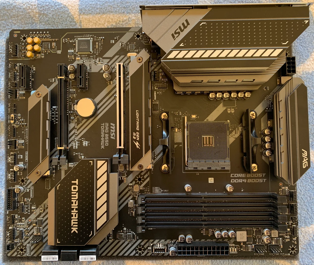 MSI MAG B550 TOMAHAWK photographed from above; rear I/O is along the upper edge.